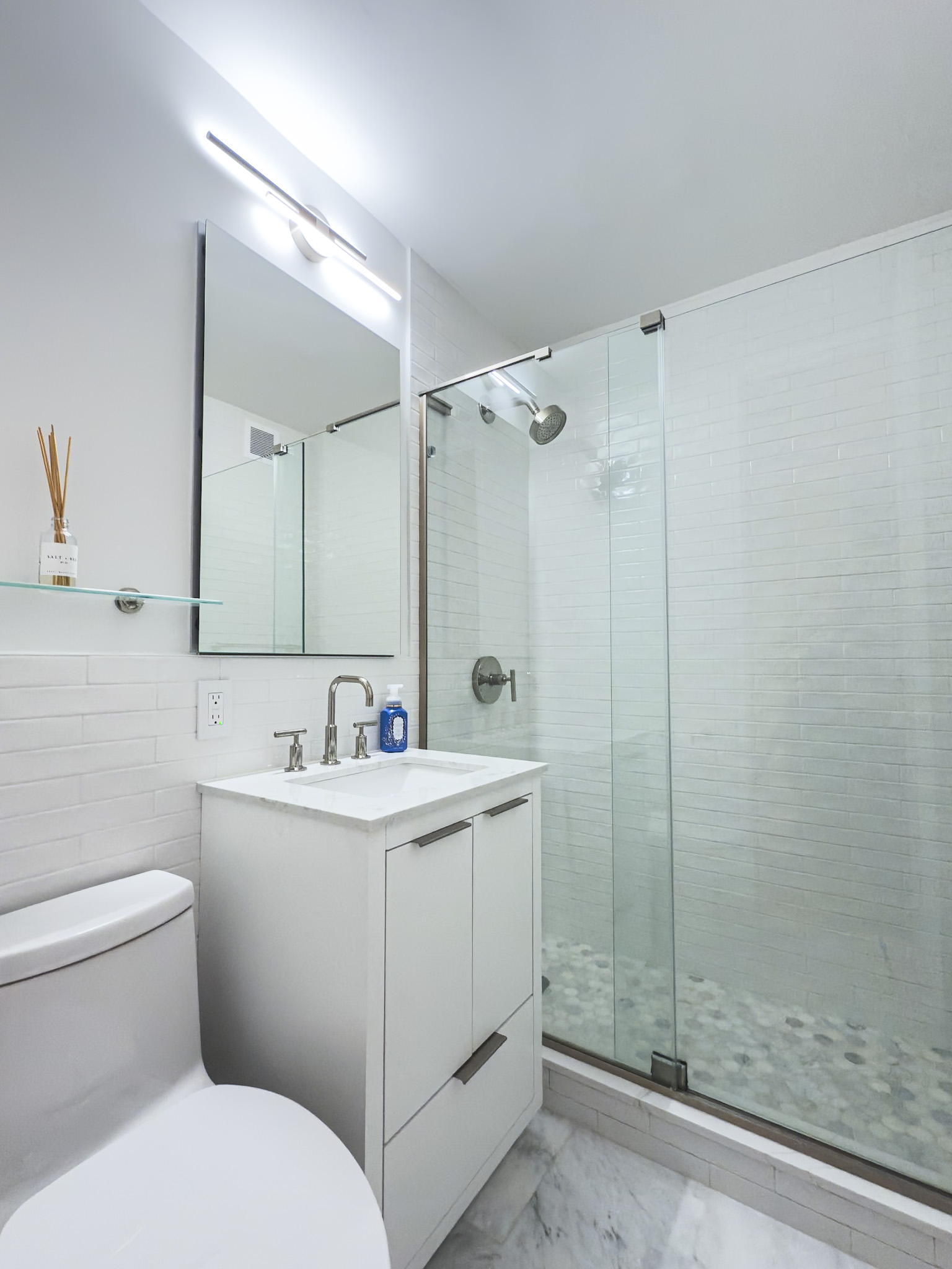 Bathroom — Carrara marble and frameless glass shower